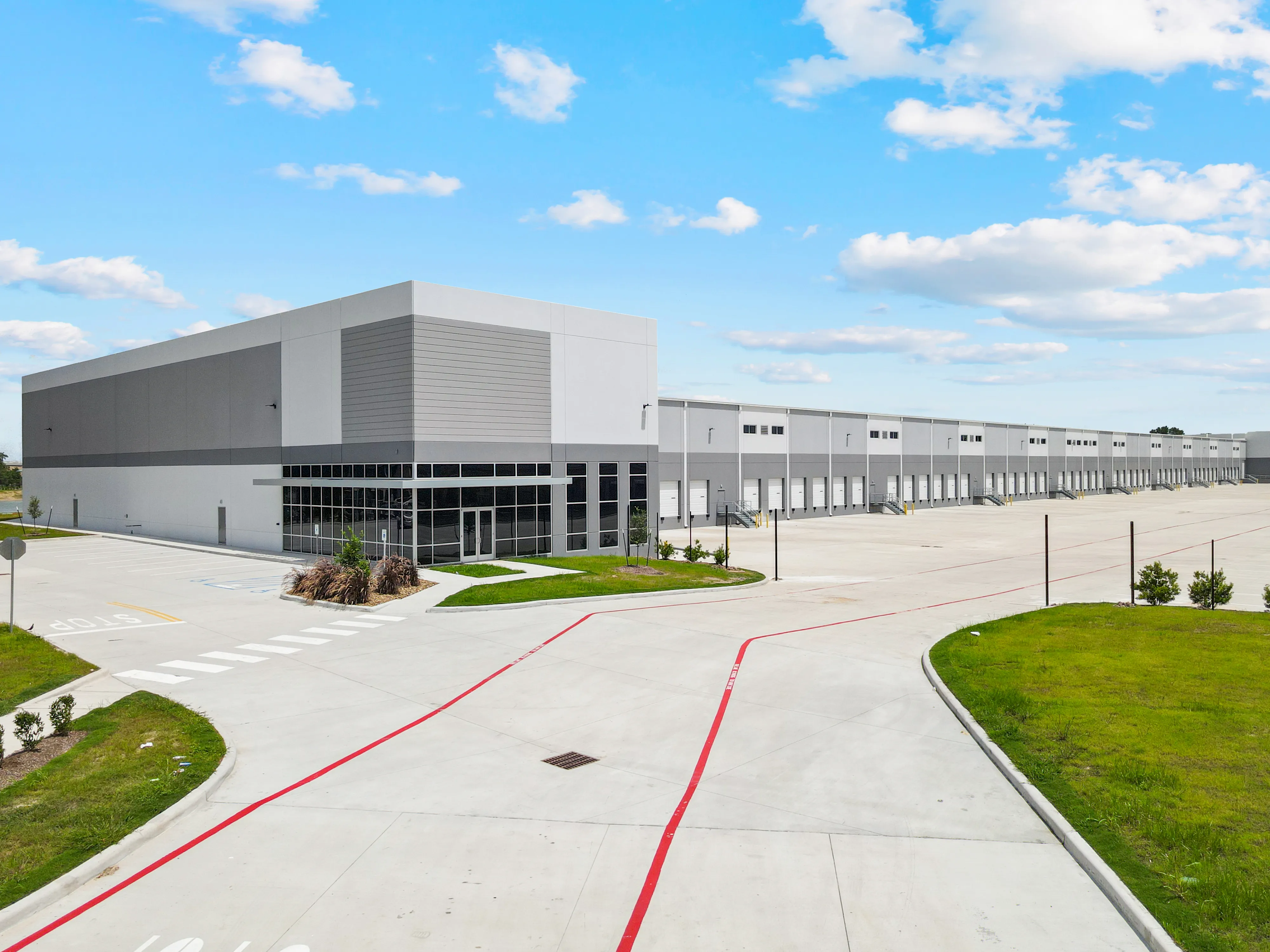 Completed industrial warehouse corner with office entry and tilt-up concrete panels