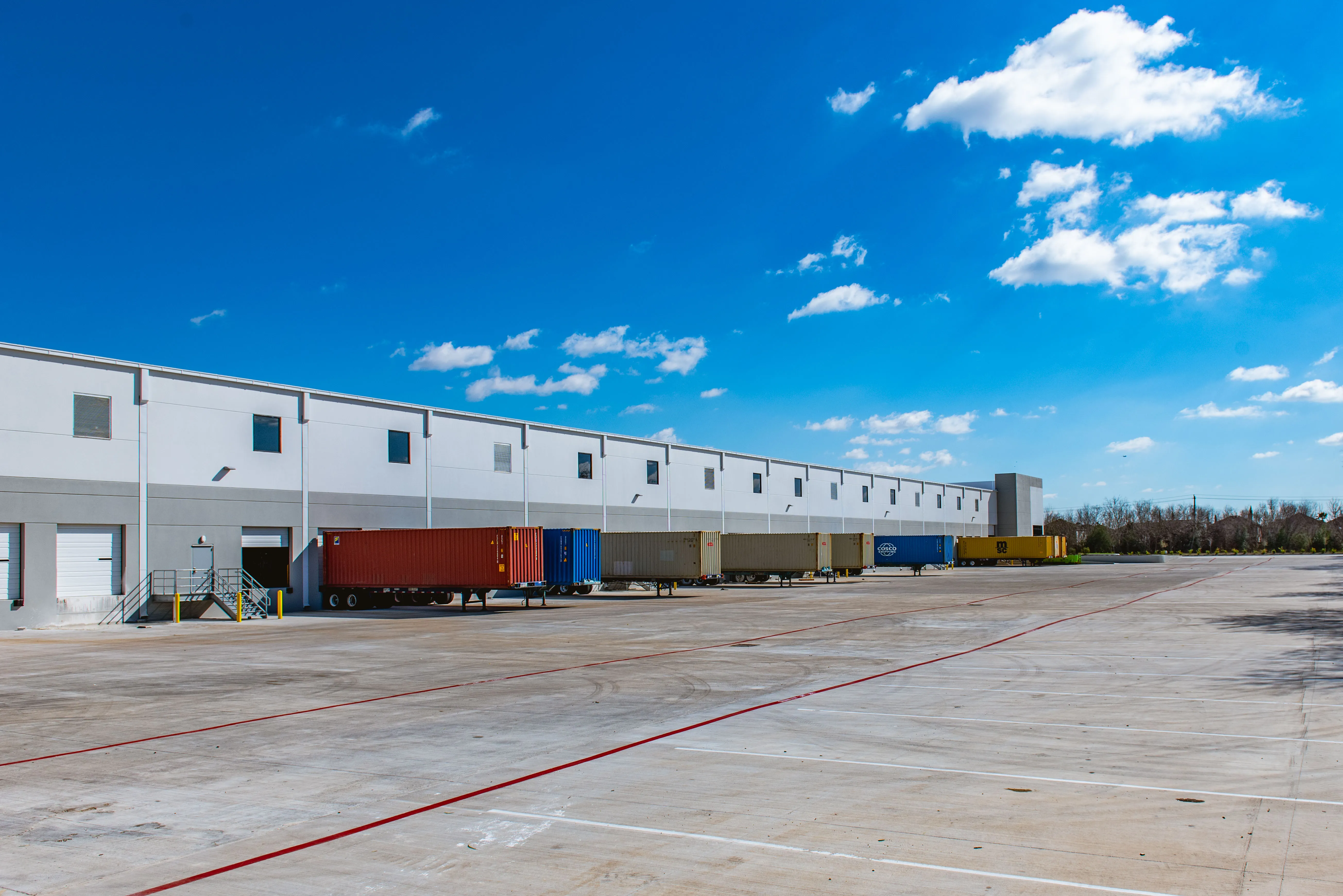 Long exterior view of the white industrial building at Southeast 45