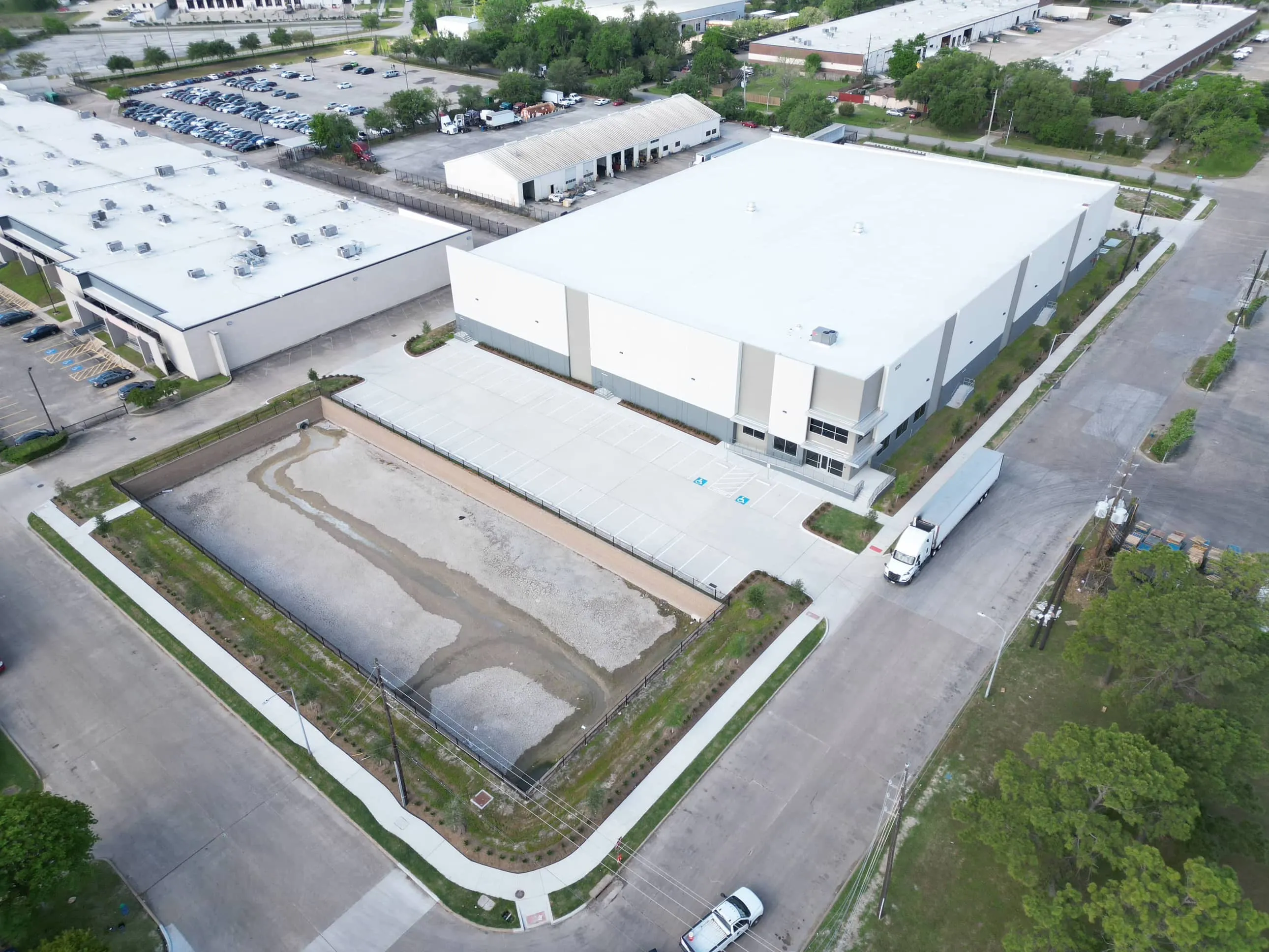 Aerial view of the industrial building and surrounding site at West X